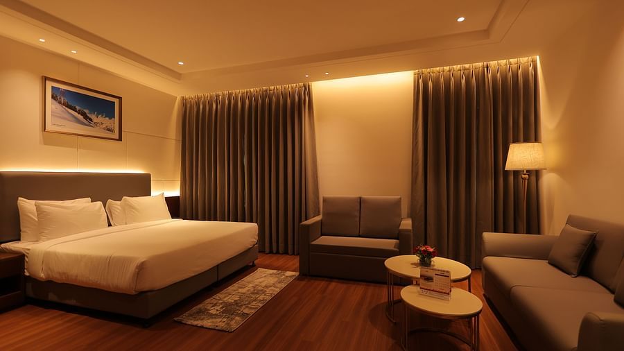 view of king size bed  and comfortable sofas of Premium Room at Pride Elite, Haridwar