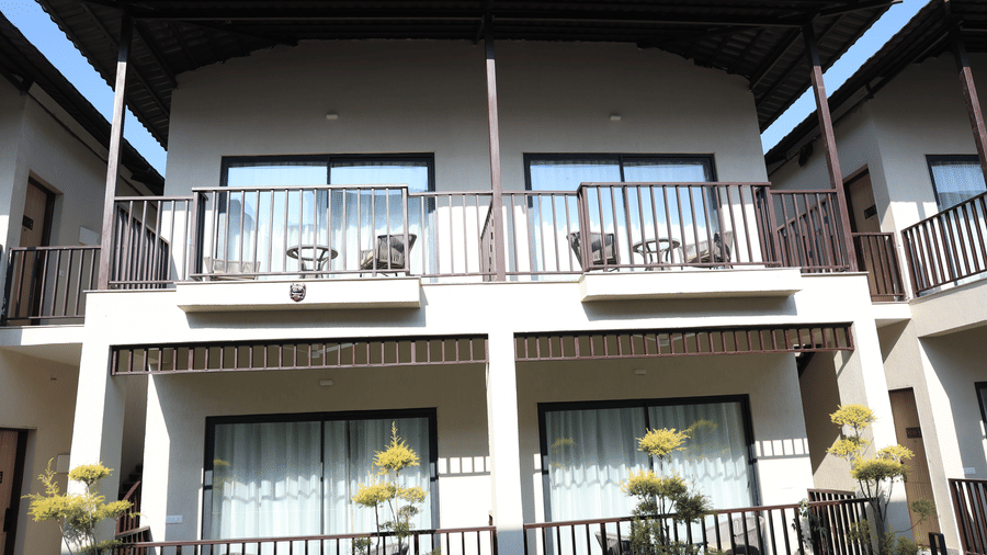 Pride Premier Alwar | A facade with the balcony of cottages with plants.