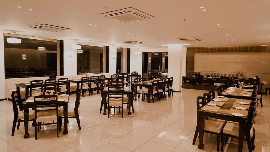 Pride Ranakpur Resort Convention Centre - interior view of the property restaurant featuring numerous tables and chairs