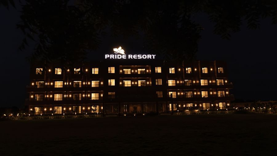 Pride Resort, Jodhpur, illuminated at night with glowing lights outlining the building’s balconies and signage.