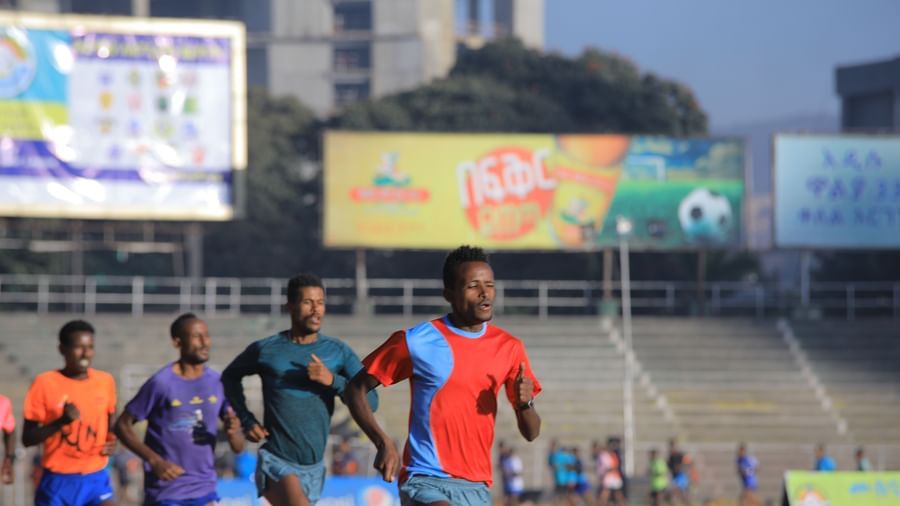Many players running on the track at Meskel Square with advertising boards in the background - Ramada by Wyndham Addis, Addis Ababa.
