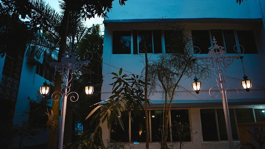 An facade image of Rangamati Garden Resort featuring two storey building with lamps style lights lit on the pathway 