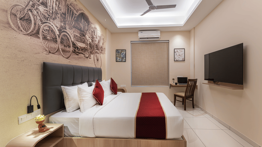 Elegant bedroom with artistic wall decor and plush bedding at Rivido - Manyata