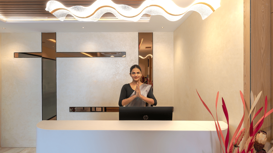 Reception desk with warm lighting and welcoming ambience at Rivido - Manyata
