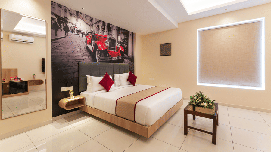 Well-appointed room with comfortable bed, seating area and soft lighting at Rivido - Manyata