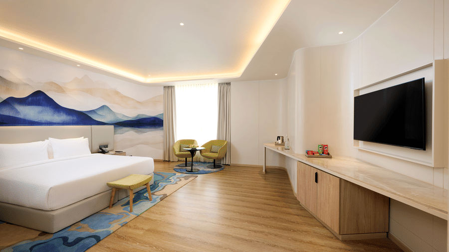 Deluxe room at Riviera Sarovar Portico, Pathankot with comfortable bedding, modern furniture and soothing decor for a restful stay.