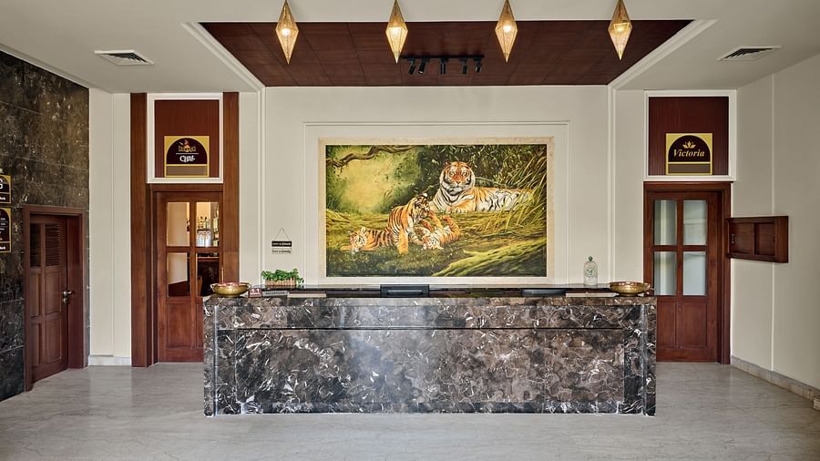 a large painting behind the reception desk - Royal Kingdom Sarovar Portico, Pilibhit