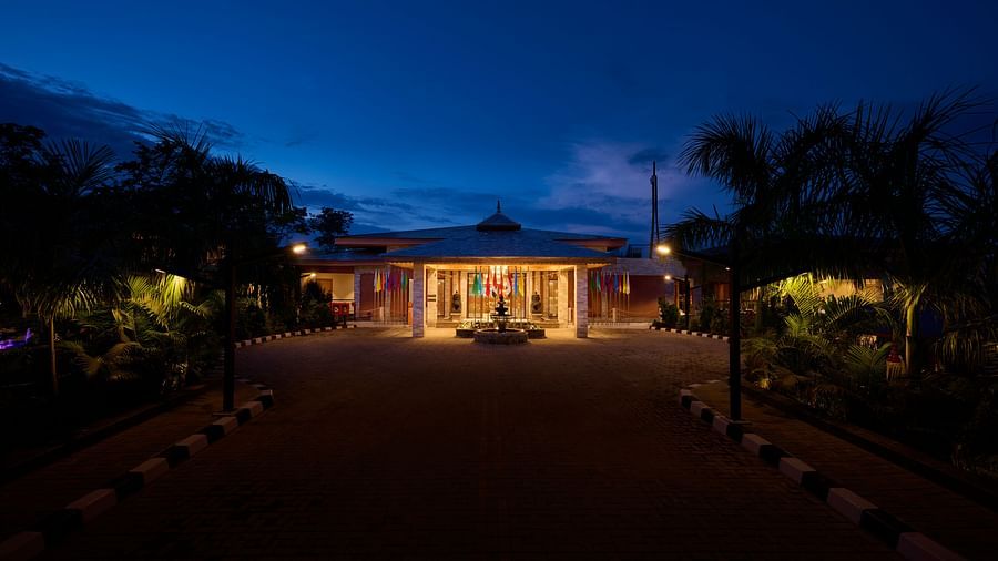 Hotel entrance at night with lights highlighting the welcoming facade - Royal Tulip, Chitwan