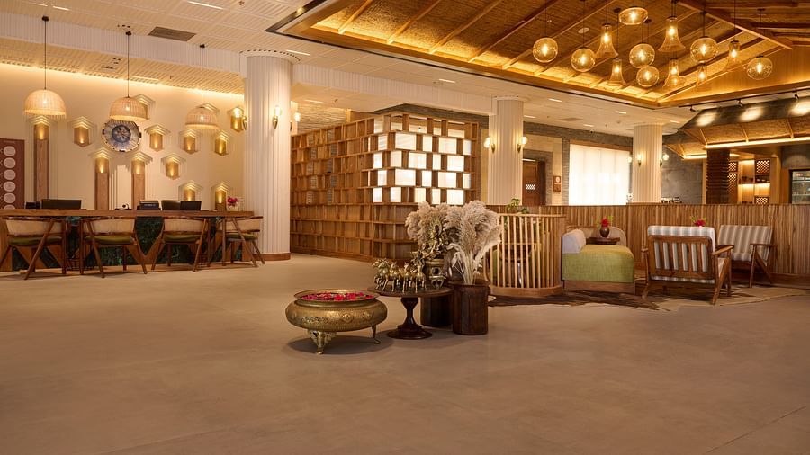 Hotel lobby with warm wooden decor, a reception desk, and ambient lighting, providing a welcoming feel - Royal Tulip, Chitwan