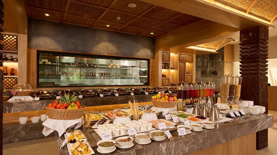 Buffet counter with decorative ceiling and well-lit serving stations - Royal Tulip, Chitwan
