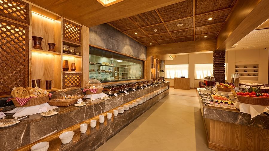 Buffet spread arranged in a warm, ambient space with wooden panelling - Royal Tulip, Chitwan