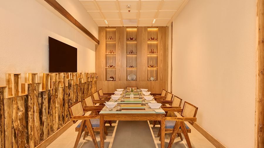 Private dining room with long table, wooden chairs, and rustic log-inspired design - Royal Tulip, Chitwan