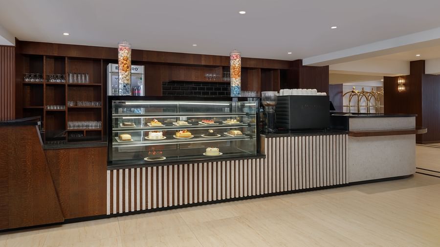 The pastry and coffee counter at Royal Tulip, Kathmandu, displaying a selection of delicious cakes and treats.