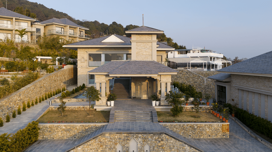 Exterior of the Royal Tulip Shivapuri National Park - Kathmandu resort showing stone architecture and manicured garden pathways.