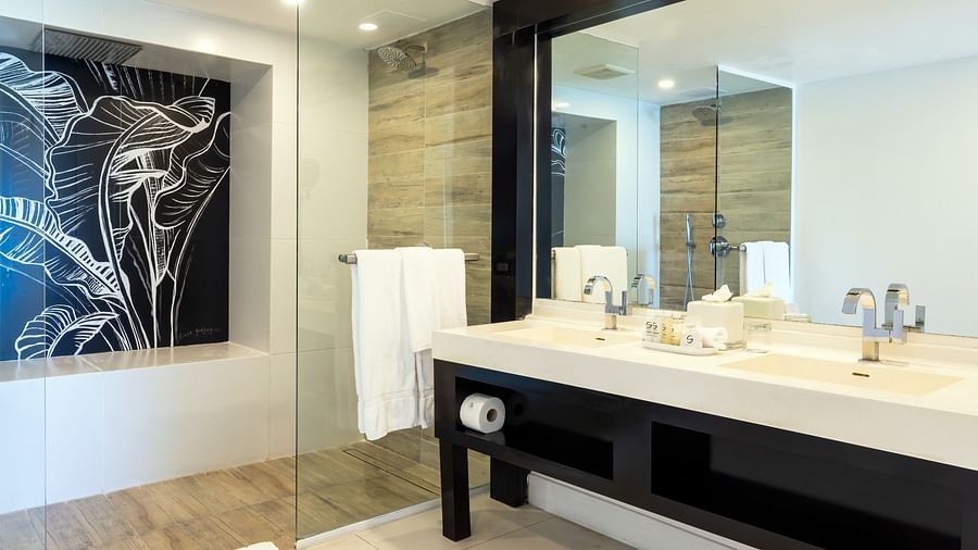 A modern bathroom at our hotel with a large sink and a wall mounted mirror - S Hotel Montego Bay, Jamaica