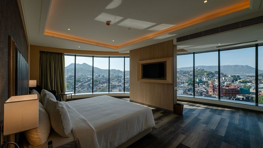 A suite in ajmer featuring a king size bed, a television and panoramic views of the city - Sarovar Portico, Ajmer