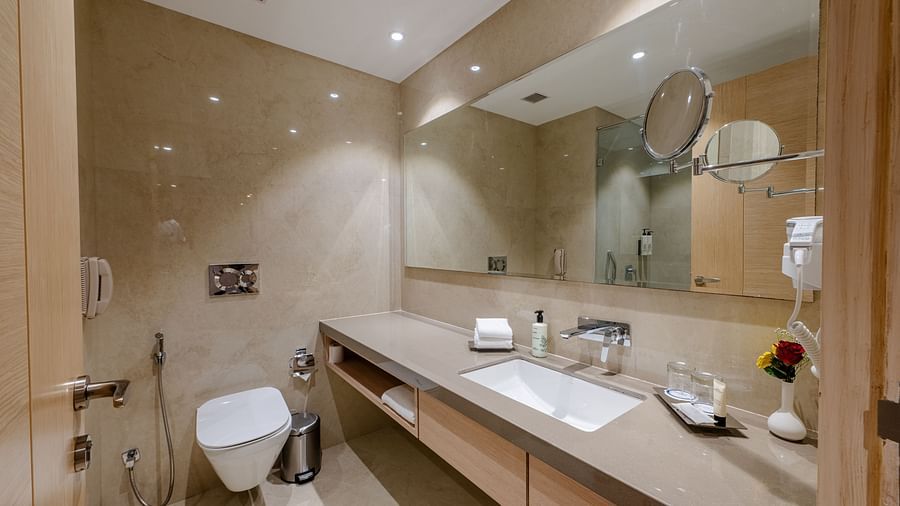 A sleek and contemporary bathroom featuring high-end fixtures, ample counter space, and modern design