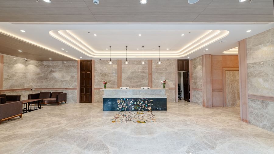 A wide angle shot of the reception desk at our hotel placed on the right of a waiting area - Sarovar Portico, Ajmer