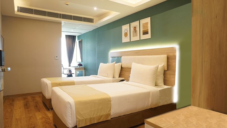 twin beds and artwork on the wall of one of the executive rooms at Sarovar Portico, Kolkata Rajarhat