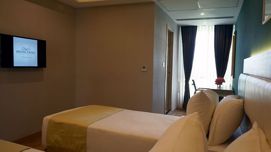 view of twin beds and a television inside one of the executive rooms at Sarovar Portico, Kolkata Rajarhat