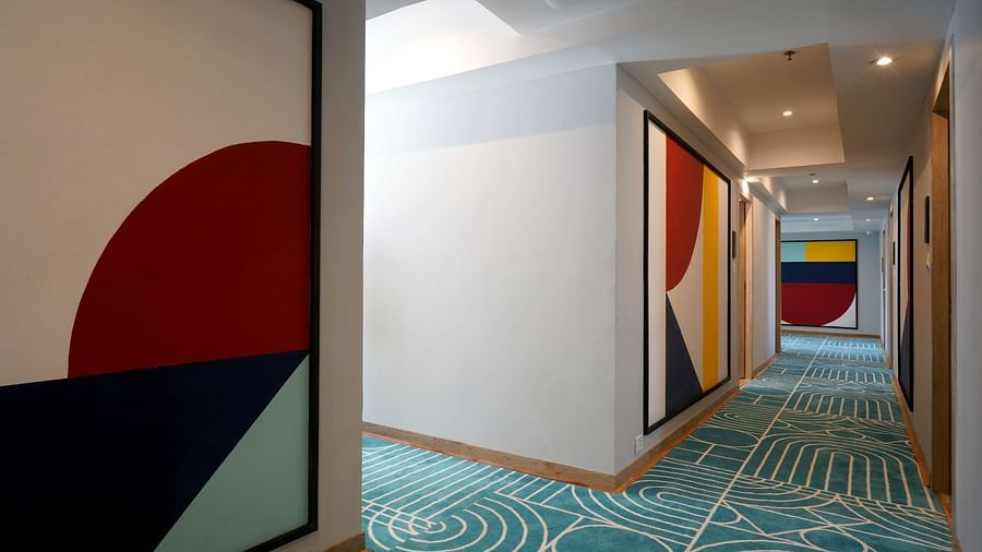 view of artwork hanging on the walls of the corridor of Sarovar Portico, Kolkata Rajarhat