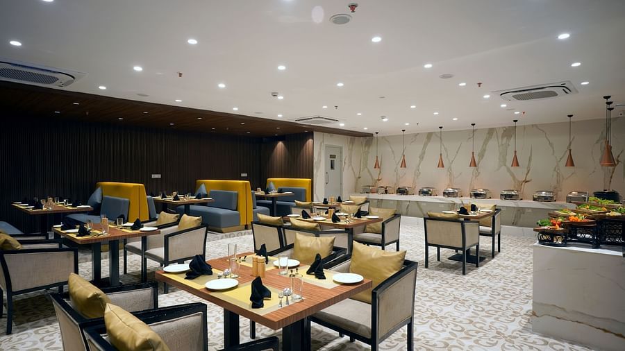 tables and buffet stations inside Golpo at Sarovar Portico, Kolkata Rajarhat