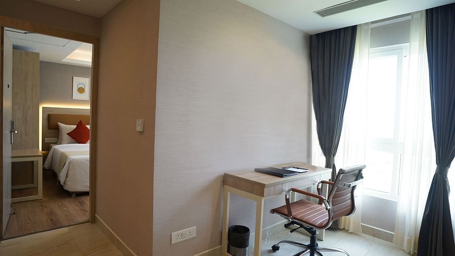 view of the work desk and chair in the living room of one of the suites at Sarovar Portico, Kolkata Rajarhat