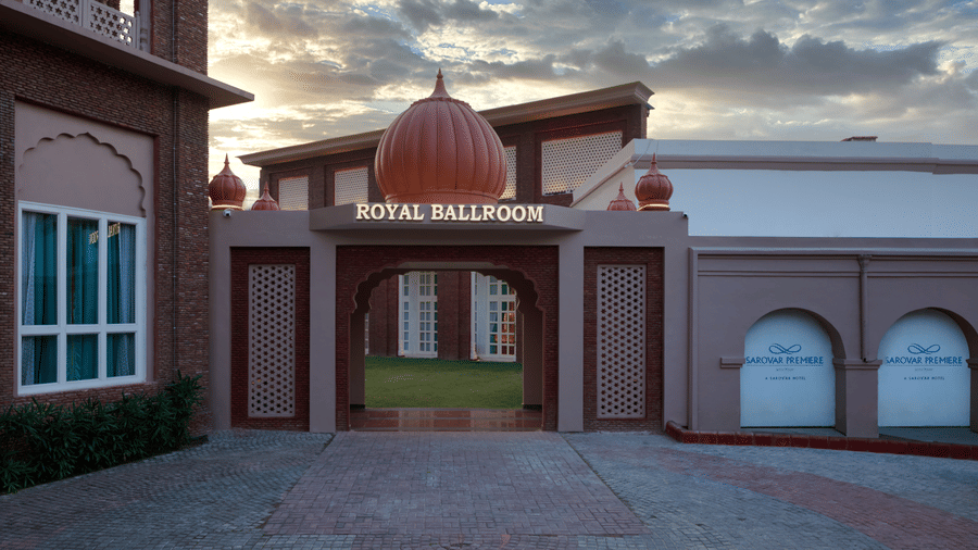 Exterior entrance view of Sarovar Premiere Amritsar with driveway and building façade.