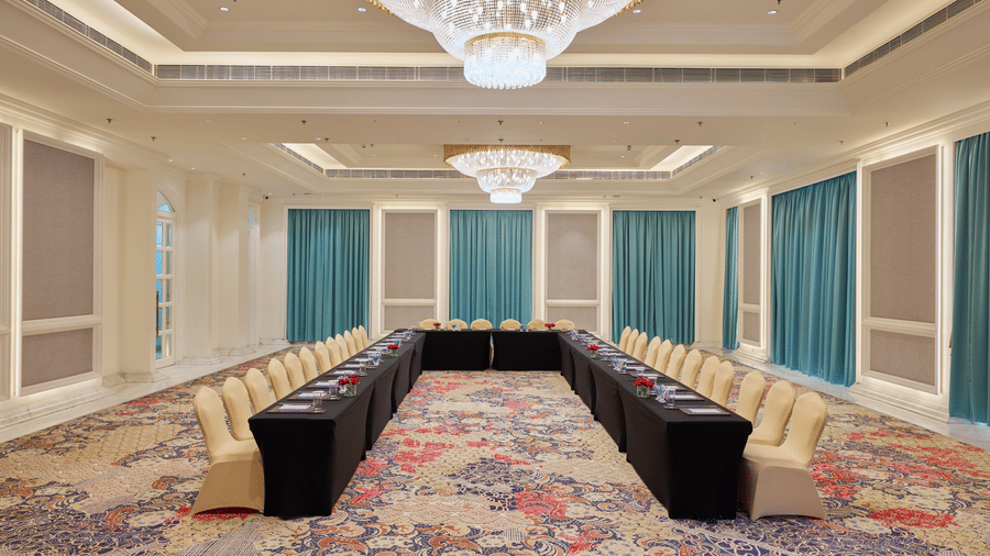 Banquet hall arranged with long tables and chairs for meetings at Sarovar Premiere Amritsar.