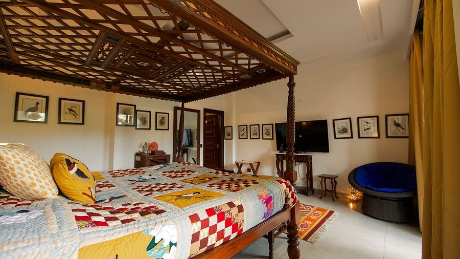 Picture featuring interior side angle view of a room with a four poster bed