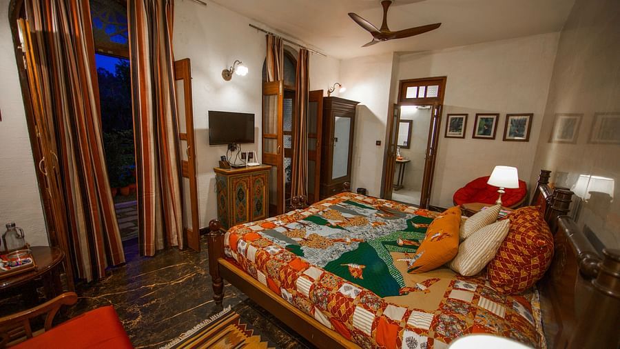 A bedroom with a large bed and a view of the outdoors.