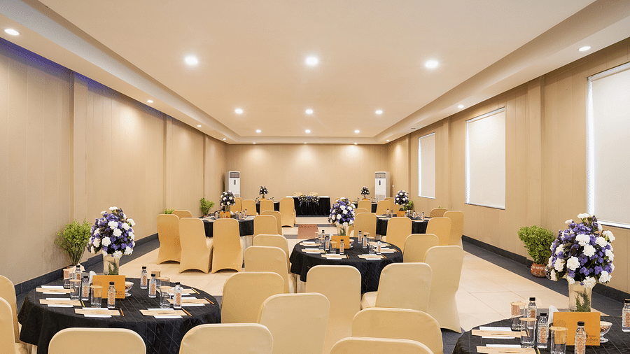Spacious conference room with a large table and chairs for seminars at Shri Radha Brij Vasundhara Resort & Spa, Mathura