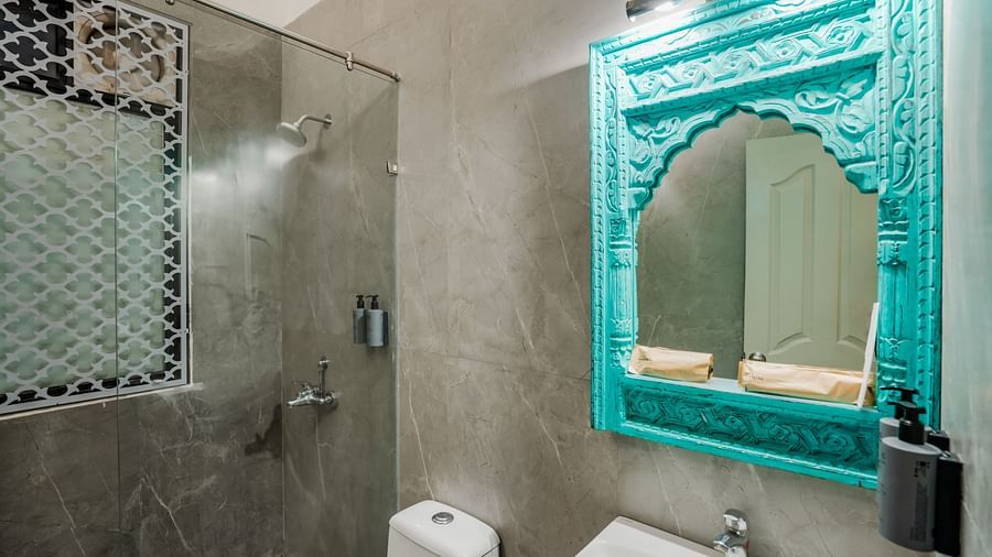 An image of a western style bathroom with mirror on the wall, a sink and faucet, showerheads, and handwash -  Shri Radha Brij Vasundhara Resort & Spa, Mathura
