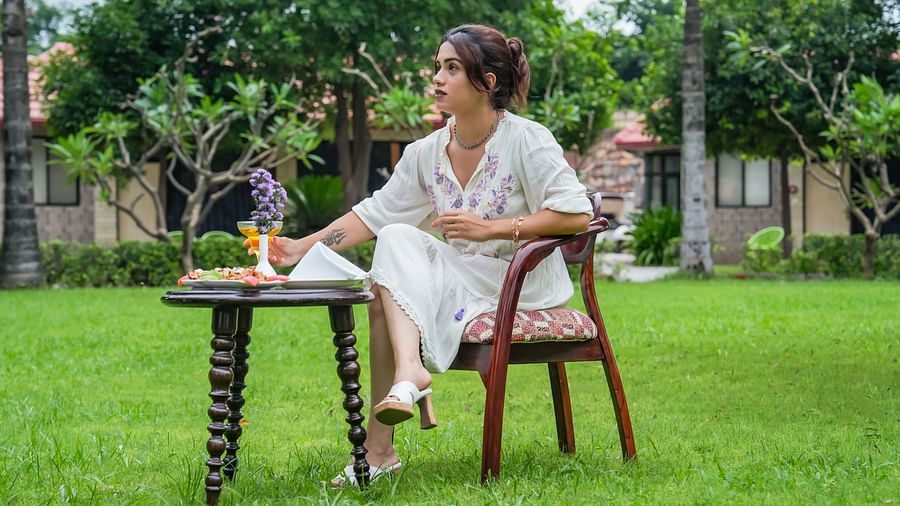 A girl enjoying a leisurely breakfast outdoors at a beautiful resort