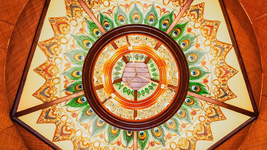 Colorful mandala ceiling design featuring intricate peacock-inspired patterns.