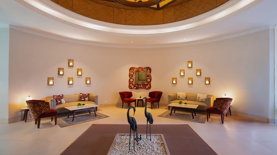 Hotel lobby seating area with elegant decor and artistic lighting.
