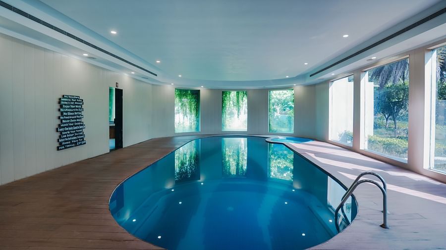 Private pool with a view of the lush green outdoors.