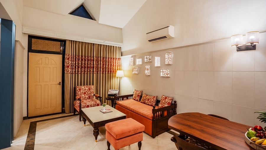 An image of a living room with sofa and centre table, another big table next to it - Shri Radha Brij Vasundhara Resort & Spa, Mathura