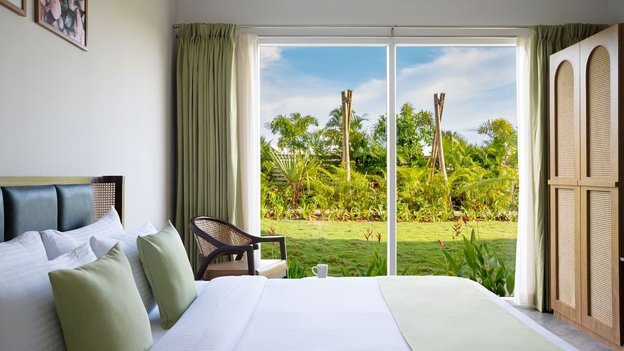 image of the bedroom of garden suite featuring the huge french windows with amazing views outside with ample natural light in the room