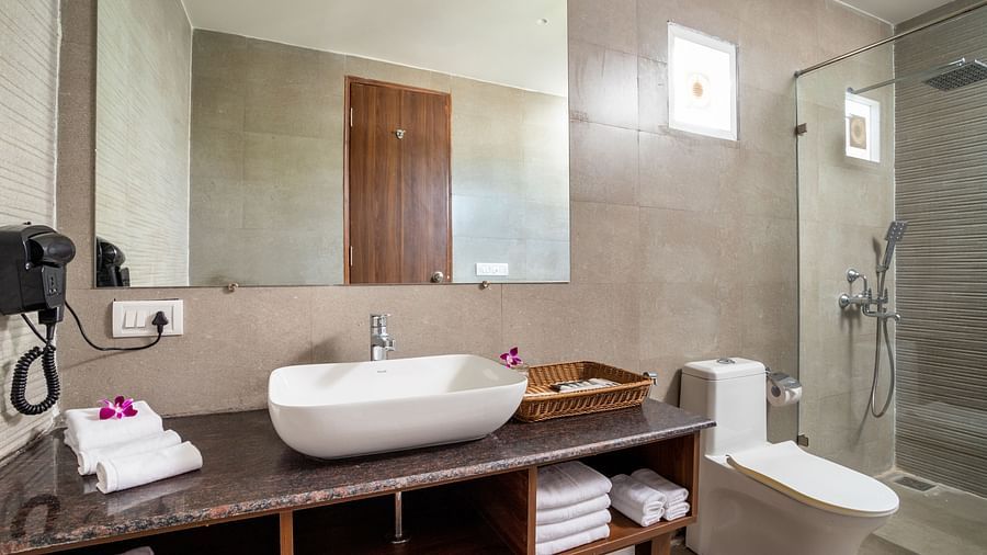 image of a well appointed bathroom featuring a huge mirror above the basin