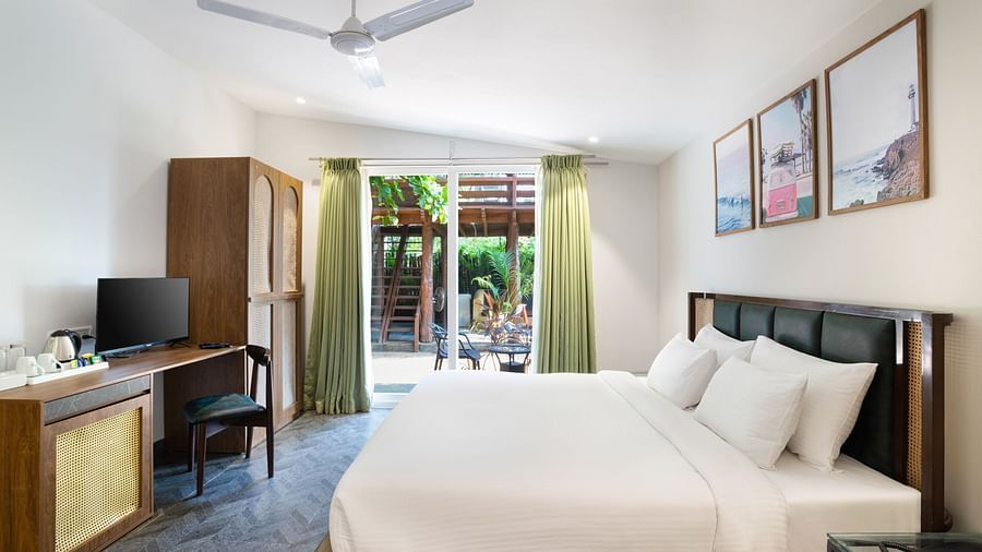 full view image of the tropical classic cottage with ample of natural light coming from the french windows at the far end of the room