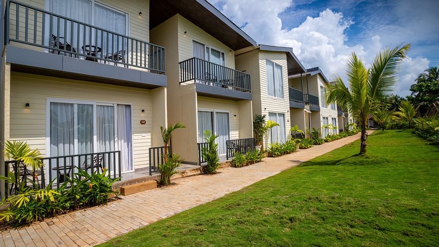 facade image featuring the exterior of sibaya beach resort, morjim beach with green lawn in front of it