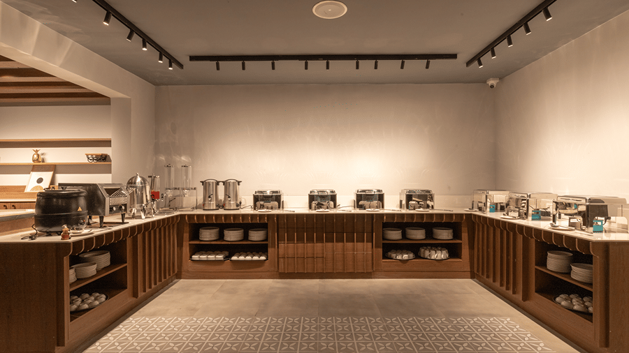Buffet spread counter and dining setup in the multi-cuisine restaurant at Sibaya Courtyard By Stone Wood Premier.