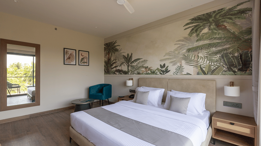 Well-appointed guest room with a king-size bed, coastal wall art and natural window light at Sibaya Courtyard By Stone Wood Premier.