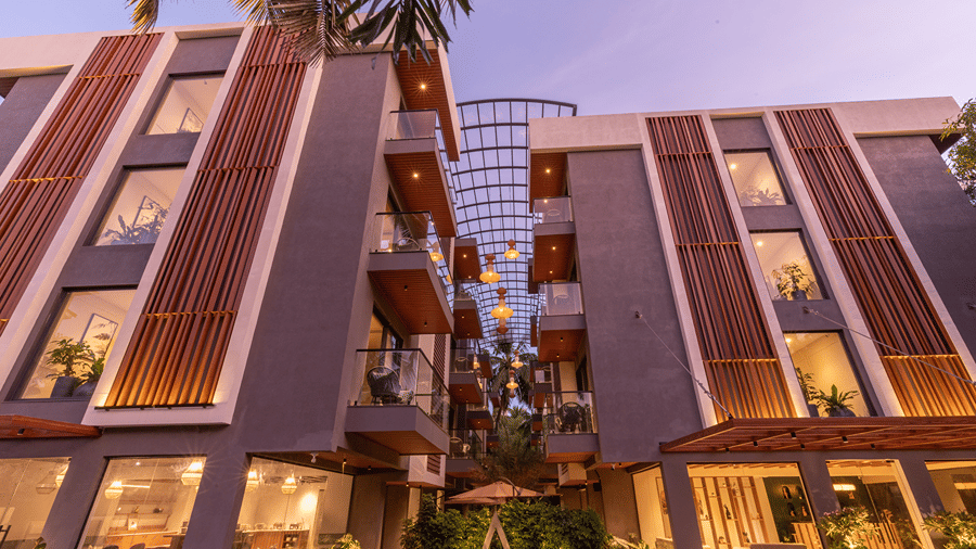 Dusk view of the modern multi-storey resort building architecture and timber accents at Sibaya Courtyard By Stone Wood Premier.