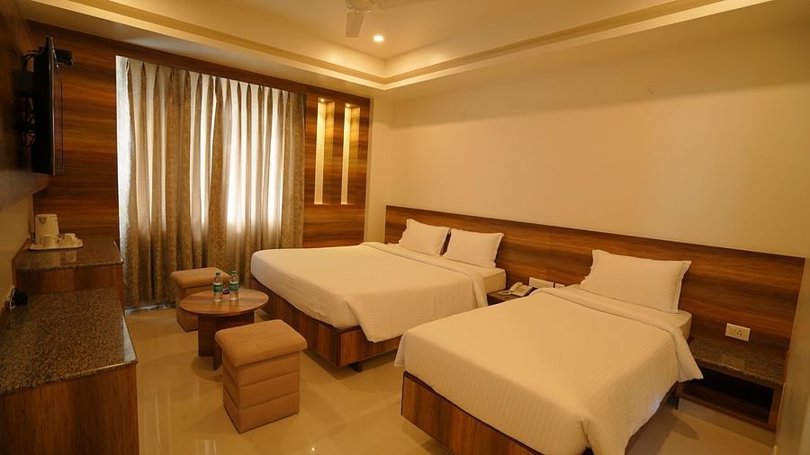 A double bed and a single bed inside standard triple room - Springs Hotel Tirupati