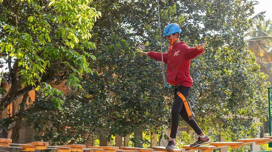 Image of a person aiming at an archery target outdoors. | Stone Wood Jungle Resort, Dandeli