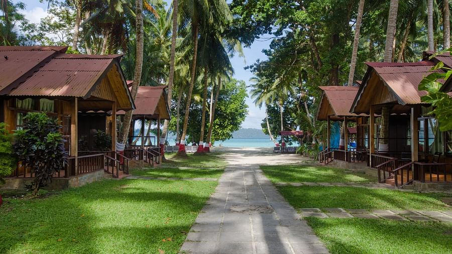 cottages on either side of the path leading up to the beach