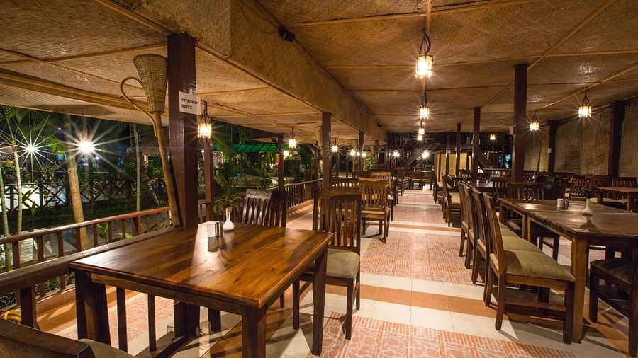 An image of the restaurant with its seating arrangement and minimal decoration - Symphony Palms Beach Resort & Spa
