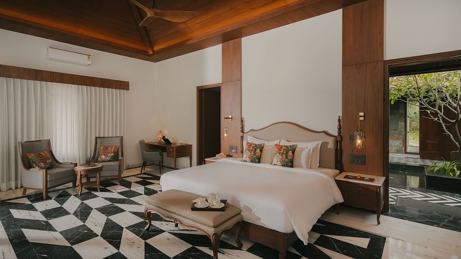 A corner view of the room at The Ananta Udaipur with a king sized bed, a flat-screen TV.